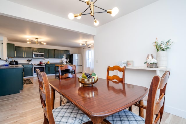 1216 Ellery Grove Ct, Vicksburg, MI 49097 - dining room with light wood finished floors and an inviting chandelier