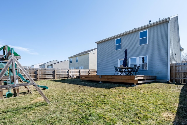 1216 Ellery Grove Ct, Vicksburg, MI 49097 - rear view of house featuring a wooden deck, a yard, a fenced backyard, and a playground