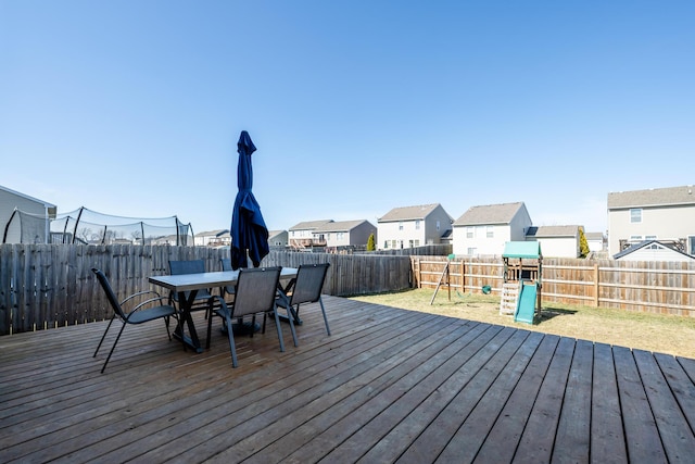 1216 Ellery Grove Ct, Vicksburg, MI 49097 - wooden deck with a fenced backyard, outdoor dining space, a residential view, and a playground