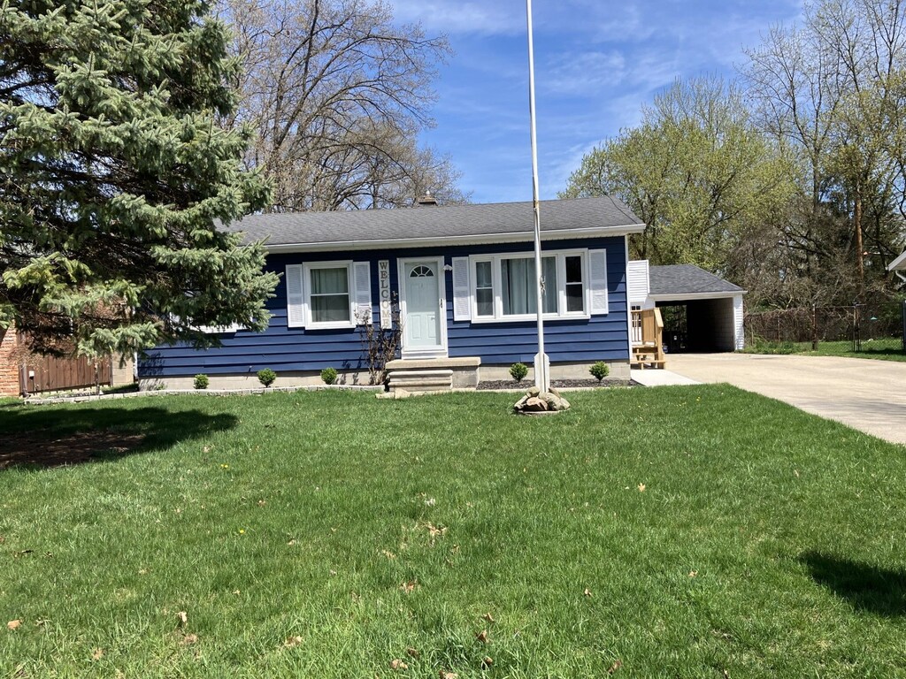2868 20th Ave, Port Huron, MI 48060 - view of front facade with a shingled roof, a front lawn, and driveway