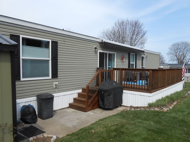 rear view of house featuring a deck