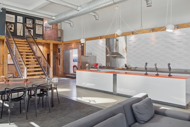 3401 Michigan Ave, Detroit, MI 48216 - kitchen featuring a high ceiling, a sink, freestanding refrigerator, wall chimney range hood, and tasteful backsplash