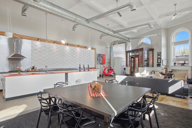 3401 Michigan Ave, Detroit, MI 48216 - dining space with beam ceiling, a ceiling fan, and a high ceiling