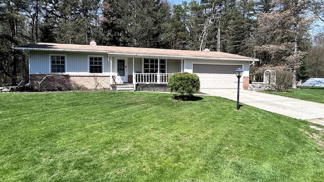 single story home with covered porch, a front yard, a chimney, concrete driveway, and an attached garage