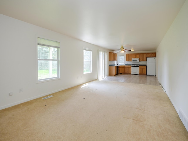 6273 S 12th St, Portage, MI 49024 - unfurnished living room featuring baseboards, light colored carpet, and visible vents