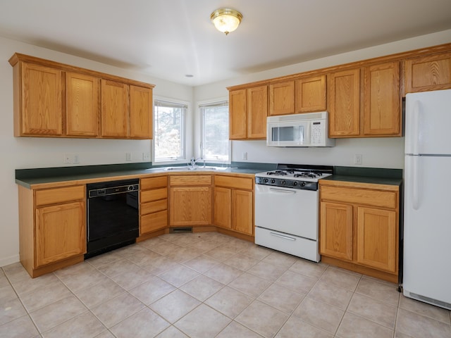 6273 S 12th St, Portage, MI 49024 - kitchen with a sink, dark countertops, light tile patterned flooring, and white appliances