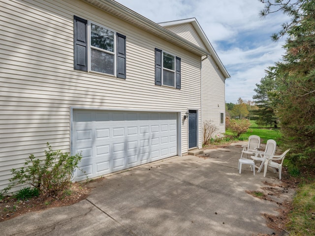 6273 S 12th St, Portage, MI 49024 - view of side of property with a garage and driveway