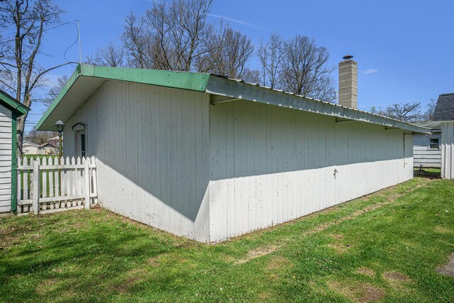 204 E Burr Oak St, Centreville, MI 49032 - view of home's exterior with fence, a chimney, and a yard