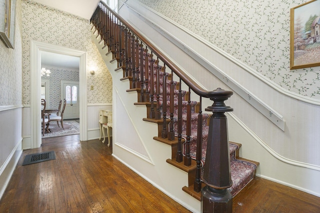 204 E Burr Oak St, Centreville, MI 49032 - stairway featuring wood-type flooring, wallpapered walls, visible vents, and a wainscoted wall