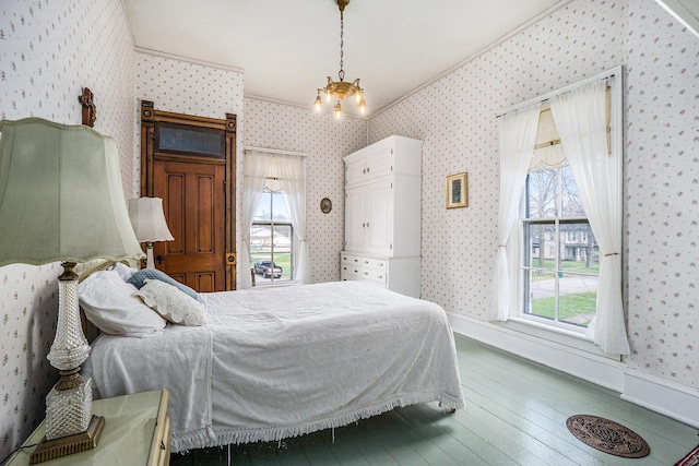 204 E Burr Oak St, Centreville, MI 49032 - bedroom featuring hardwood / wood-style flooring, an inviting chandelier, multiple windows, and wallpapered walls