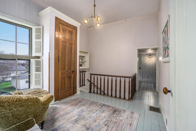 204 E Burr Oak St, Centreville, MI 49032 - entrance foyer with visible vents, a notable chandelier, and wood-type flooring