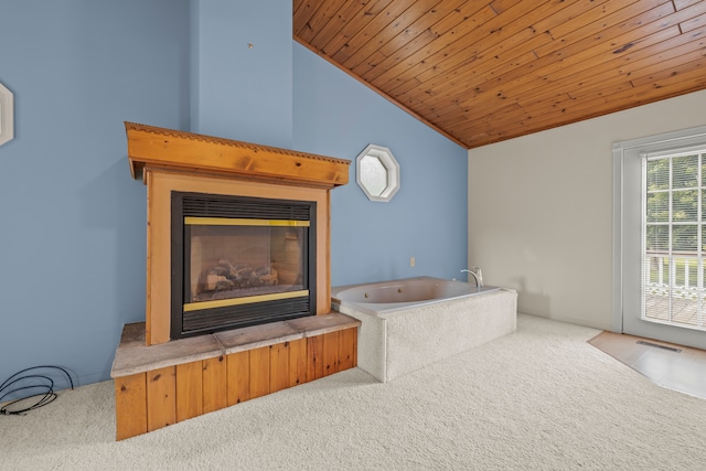 2316 Sugar Riv, Gladwin, MI 48624 - bathroom featuring a glass covered fireplace, a washtub, lofted ceiling, visible vents, and wood ceiling