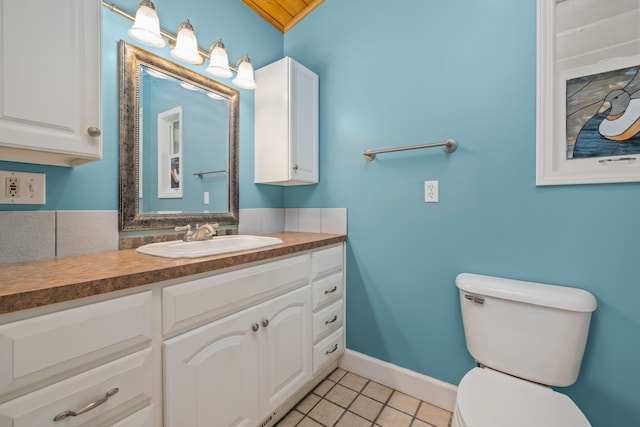 2316 Sugar Riv, Gladwin, MI 48624 - bathroom featuring vanity, tile patterned flooring, baseboards, and toilet