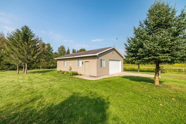 2316 Sugar Riv, Gladwin, MI 48624 - back of house with an outdoor structure, a yard, and a detached garage