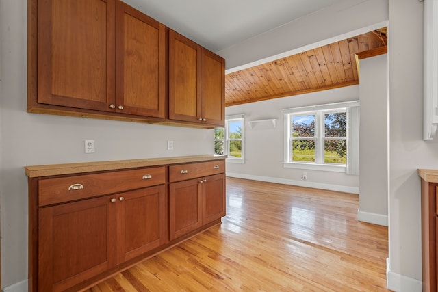 2316 Sugar Riv, Gladwin, MI 48624 - kitchen featuring brown cabinets, light countertops, baseboards, and light wood-type flooring
