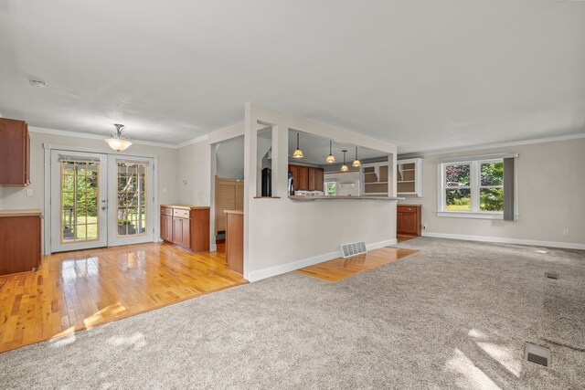 2316 Sugar Riv, Gladwin, MI 48624 - unfurnished living room with french doors, baseboards, light colored carpet, and a wealth of natural light