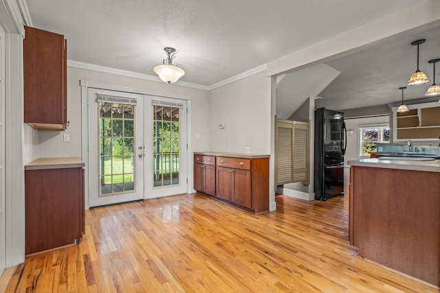 2316 Sugar Riv, Gladwin, MI 48624 - kitchen with crown molding, light wood-style floors, french doors, freestanding refrigerator, and a wealth of natural light