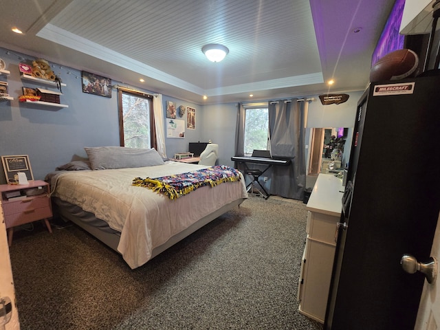 bedroom featuring a tray ceiling and carpet flooring
