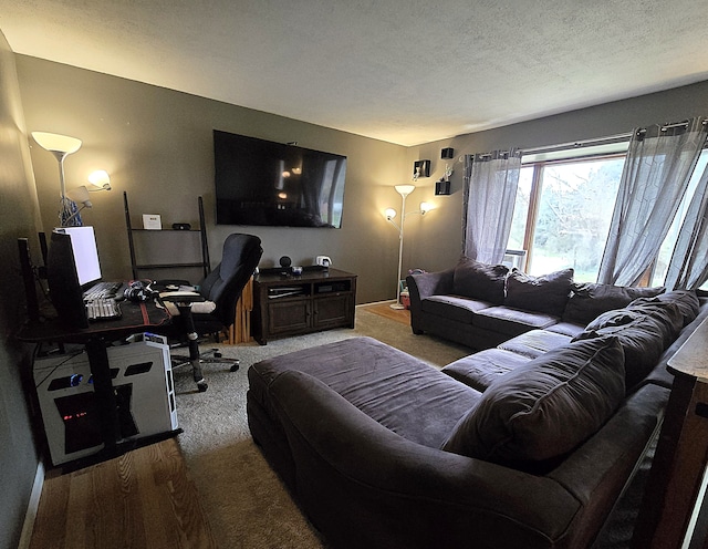 carpeted living room with a desk and a textured ceiling