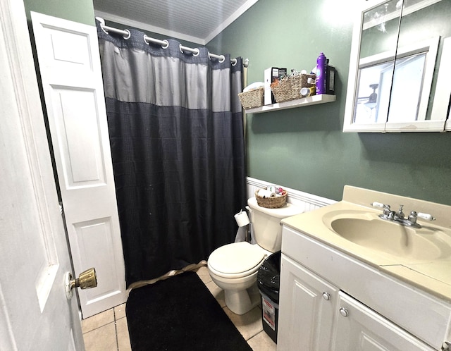 bathroom with tile patterned flooring, toilet, vanity, and curtained shower