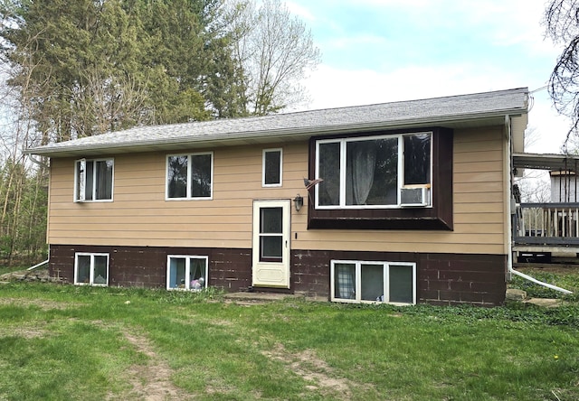 rear view of house featuring a yard