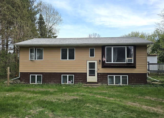 back of house with a lawn