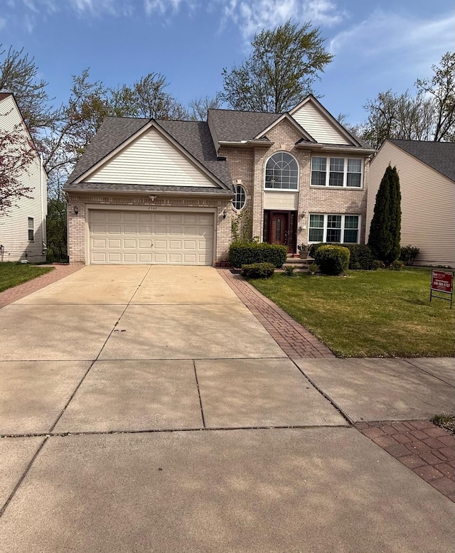 view of front facade featuring a front yard, brick siding, a shingled roof, concrete driveway, and an attached garage