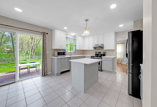 kitchen featuring a sink, light countertops, a center island, stainless steel appliances, and under cabinet range hood