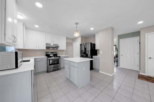 kitchen with white cabinets, appliances with stainless steel finishes, light tile patterned floors, under cabinet range hood, and a kitchen island