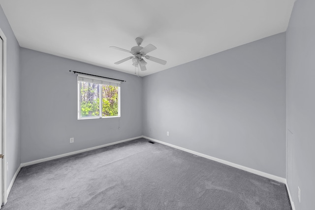unfurnished room featuring baseboards, a ceiling fan, and carpet floors