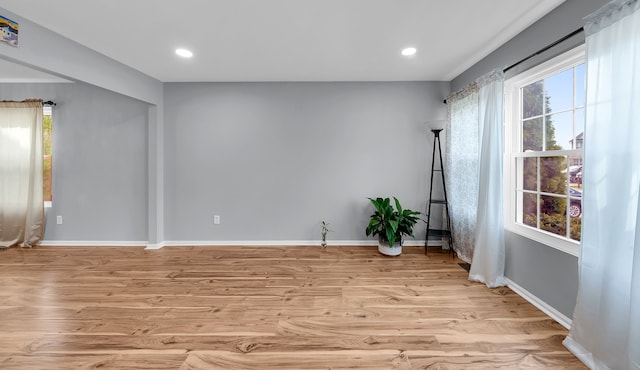 empty room featuring light wood-style floors, recessed lighting, and baseboards