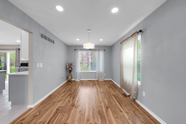 unfurnished dining area with recessed lighting, baseboards, and visible vents
