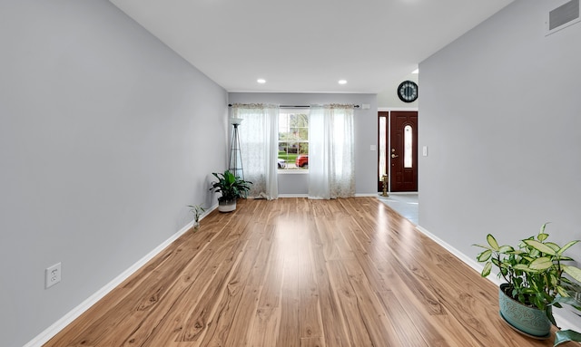 entrance foyer with recessed lighting, baseboards, light wood finished floors, and visible vents