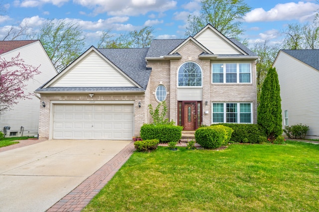 traditional home featuring brick siding, a front lawn, an attached garage, and driveway