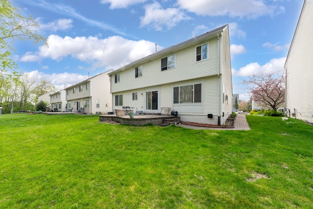 back of property featuring a lawn and a patio