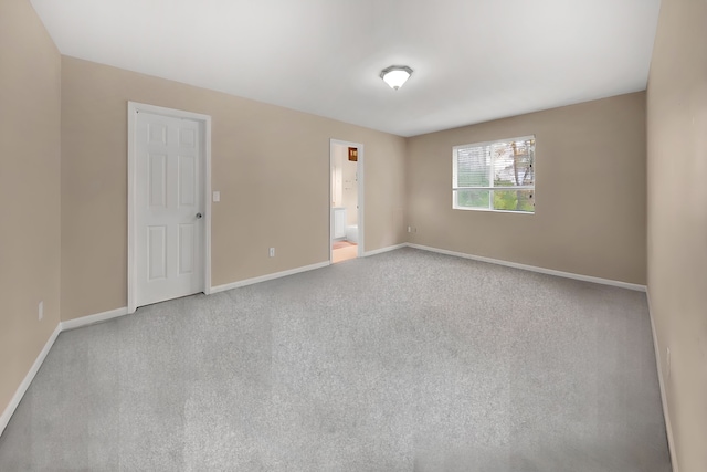 unfurnished room featuring baseboards and carpet flooring