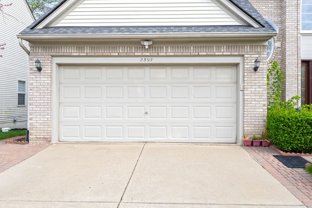 garage featuring concrete driveway