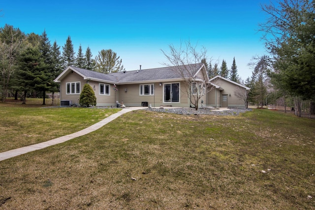 9681 Sugar Bush Run, Traverse City, MI 49685 - rear view of house featuring central AC unit and a yard