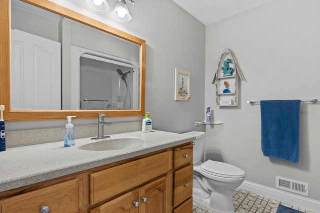 9681 Sugar Bush Run, Traverse City, MI 49685 - bathroom featuring visible vents, baseboards, toilet, vanity, and tile patterned flooring