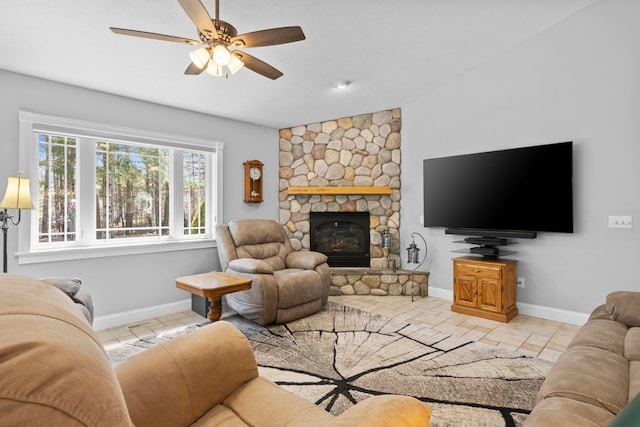 9681 Sugar Bush Run, Traverse City, MI 49685 - living room featuring baseboards, ceiling fan, and a stone fireplace