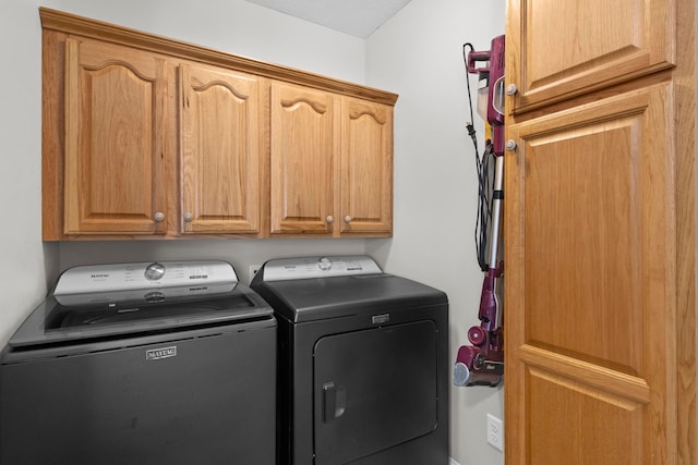 9681 Sugar Bush Run, Traverse City, MI 49685 - laundry area featuring separate washer and dryer and cabinet space
