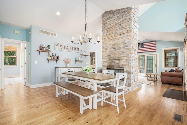 dining space featuring light wood-type flooring, visible vents, and an inviting chandelier