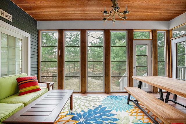 sunroom with wood ceiling and an inviting chandelier