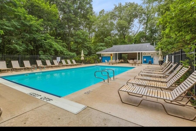 pool featuring a patio area and fence