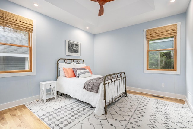 bedroom with recessed lighting, light wood-style floors, and baseboards