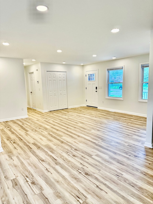 entryway with baseboards, recessed lighting, and light wood-style floors