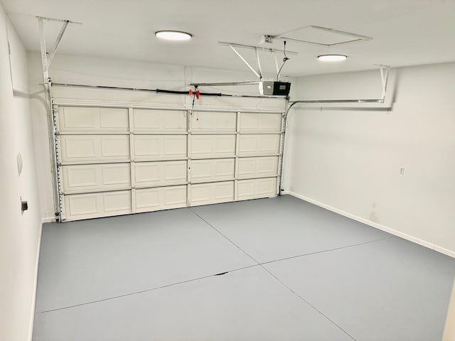 garage featuring baseboards and a garage door opener