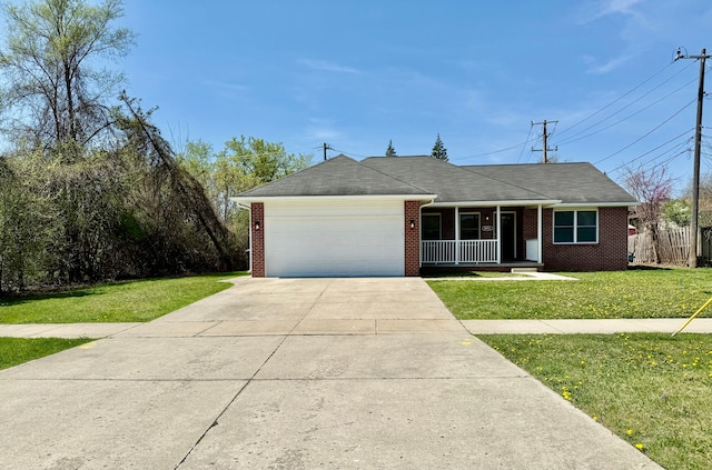 ranch-style home featuring a porch, concrete driveway, a front yard, and a garage