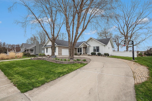 5591 Pioneer Ave, Saint Joseph, MI 49085 - single story home featuring a front lawn, brick siding, curved driveway, and a garage