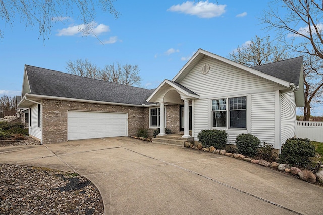 5591 Pioneer Ave, Saint Joseph, MI 49085 - ranch-style house featuring brick siding, an attached garage, driveway, and a shingled roof